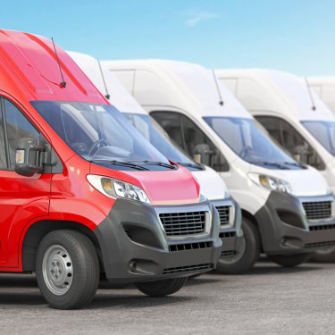 red-delivery-van-in-a-row-of-white-vans-best-expr-2023-11-27-05-17-58-utc